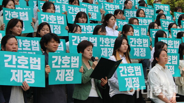 간호대학 학생들과 교수진이 대강당 앞 계단에서 기자회견을 하고 있다. <strong>신예린 기자