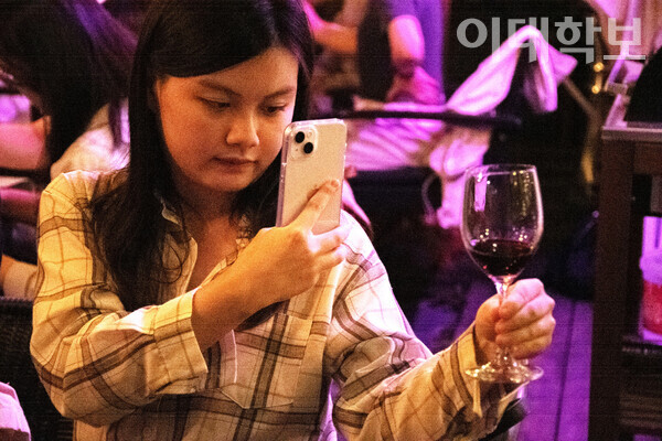 시음 중인 레드 와인을 공들여 찍고 있는 와이니 부원의 모습. <strong>박소현 사진기자
