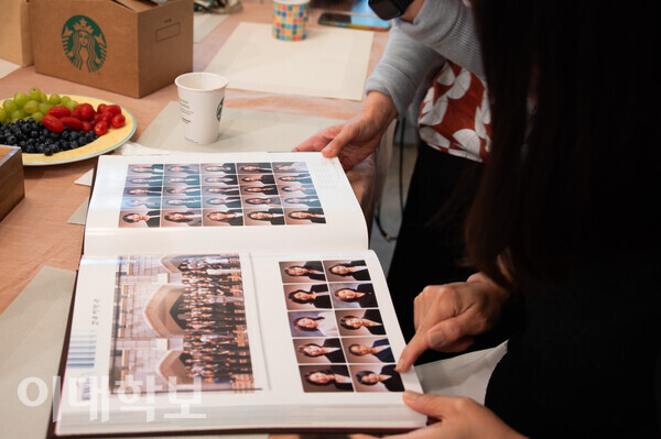 김경미씨의 자택에 이영완 회장 및 차세대 동창들이 모여 졸업 앨범을 보고 있다. 김경미씨는 졸업 사진 촬영시 방문했던 미용실을 떠올리며 추억에 잠겼다. <strong>안정연 사진기자