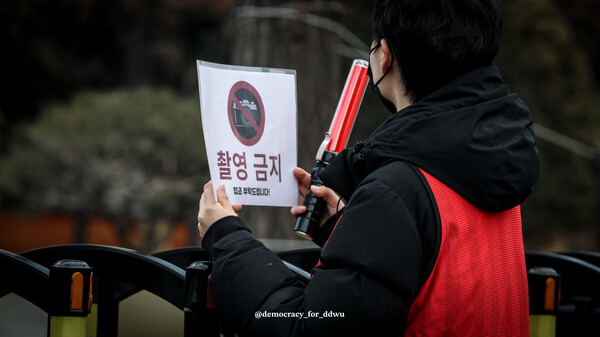1월19일 열린 2차 '민주없는 민주동덕' 시위. 주황색 형광 조끼를 입은 스태프가 '촬영 금지' 안내문을 들고 있다. 제공=민주없는 민주동덕