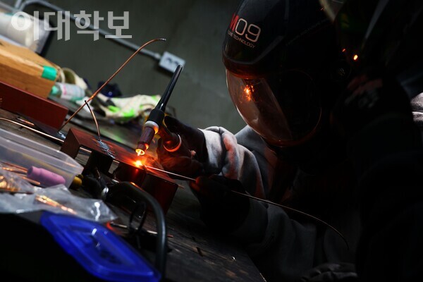 배문영(휴기바·23)씨가 용접 시범을 보이고 있다. 강한 불빛이 튀고 불씨가 남은 모습. 정영인 사진기자